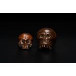 Two wooden memento mori skulls, 17/18th C.