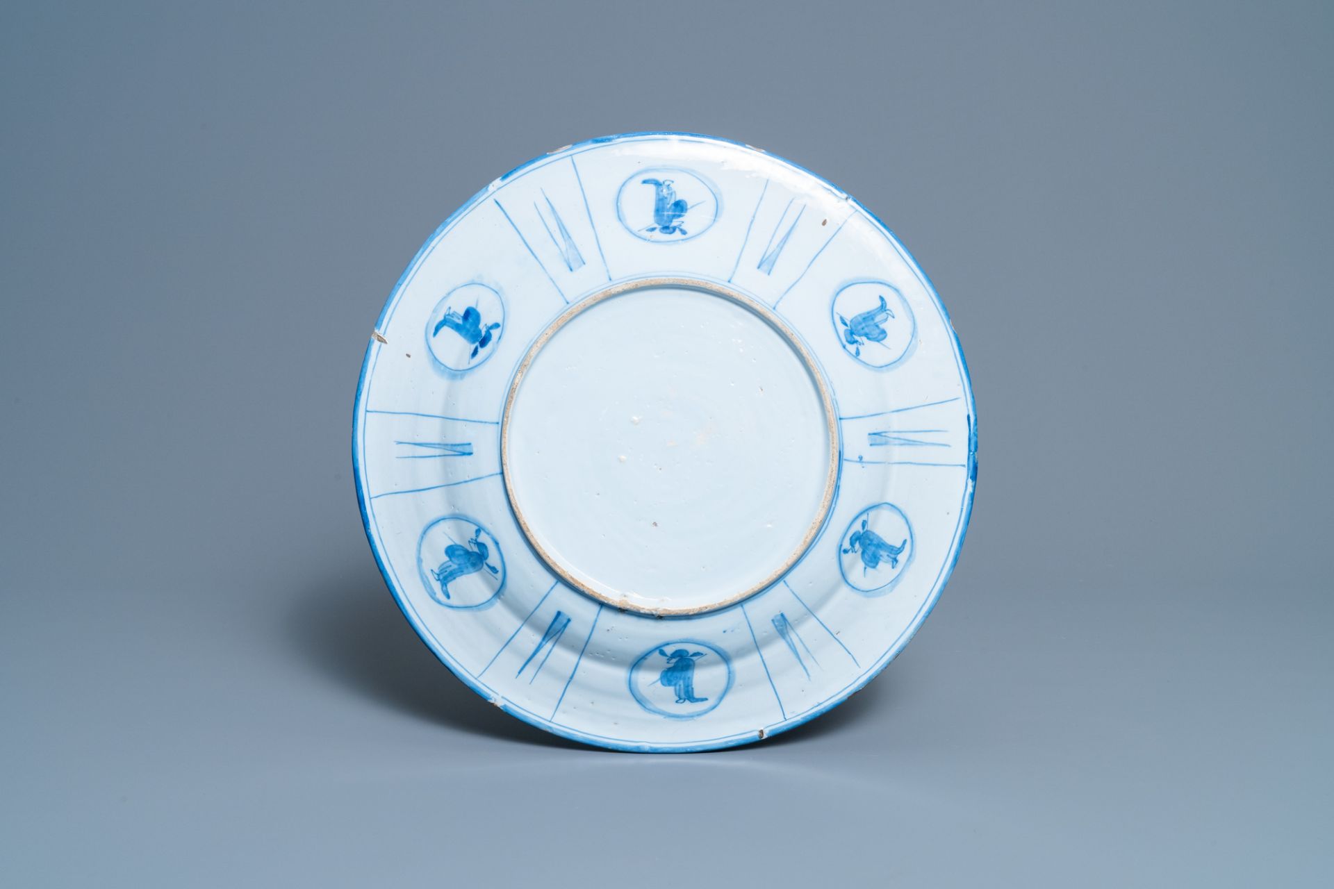 A Dutch Delft blue and white chinoiserie dish with figurative medallions on the back, late 17th C. - Image 2 of 2