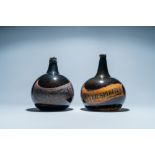 Two large dark green glass bottles with painted inscriptions, 17/18th C.