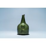 A green glass wine bottle with a crowned alliance seal, 17th C.