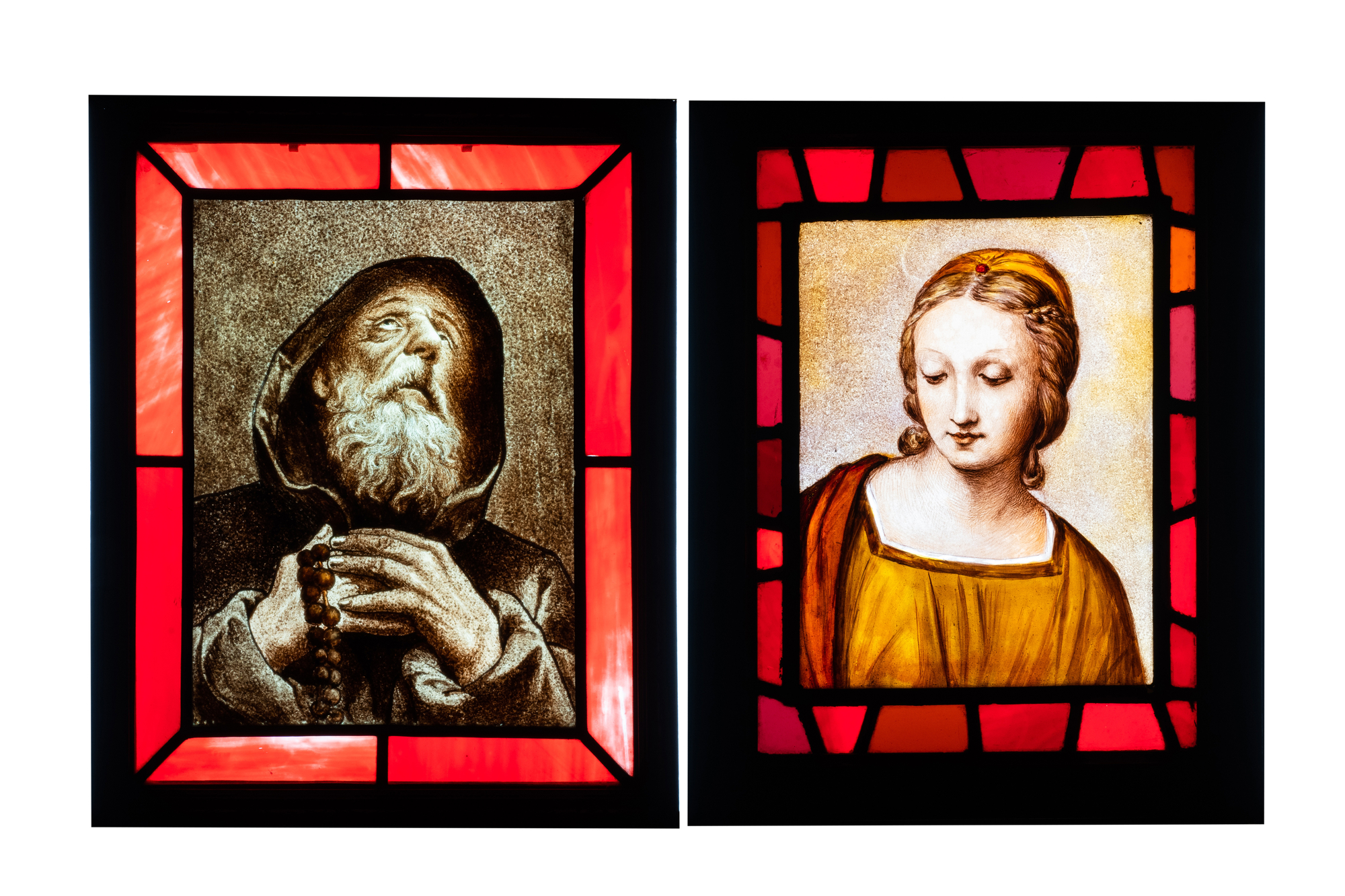 Two composite stained and painted glass windows with a monk and a female bust after Rapha‘l, 19th C.