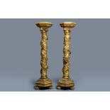 A pair of gilded wooden columns with Ionic capitals, floral swirls and lion paws, Italy, 18th C.