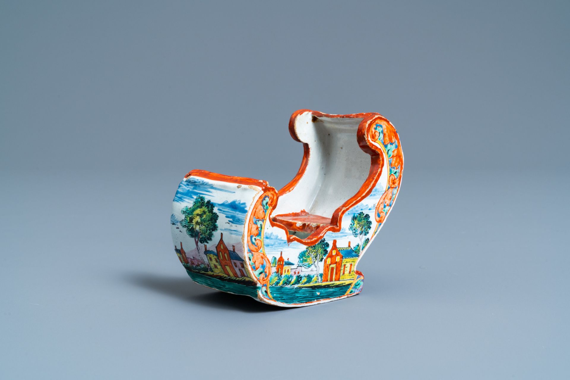 A polychrome Dutch Delft petit feu pipe stand modelled as a sleigh, 18th C.