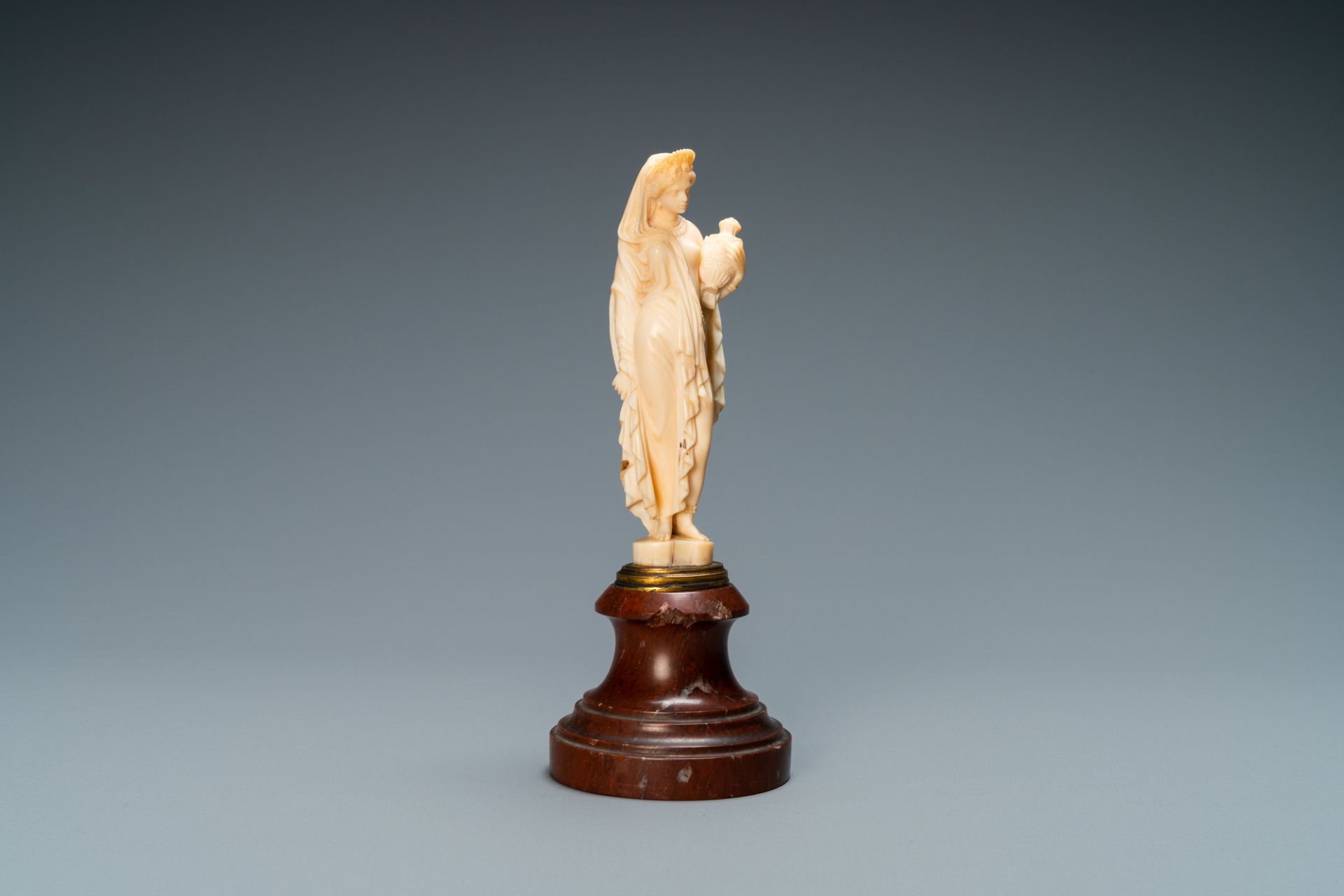 An ivory figure of a woman dressed after the antique holding a vase, probably Dieppe, France, 19th C