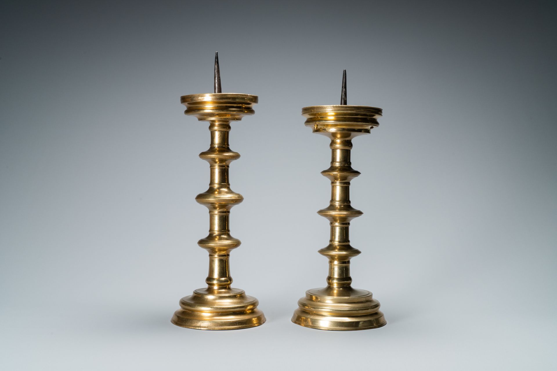 A composite pair of brass alloy candlesticks, Germany, 16th C. - Image 5 of 7