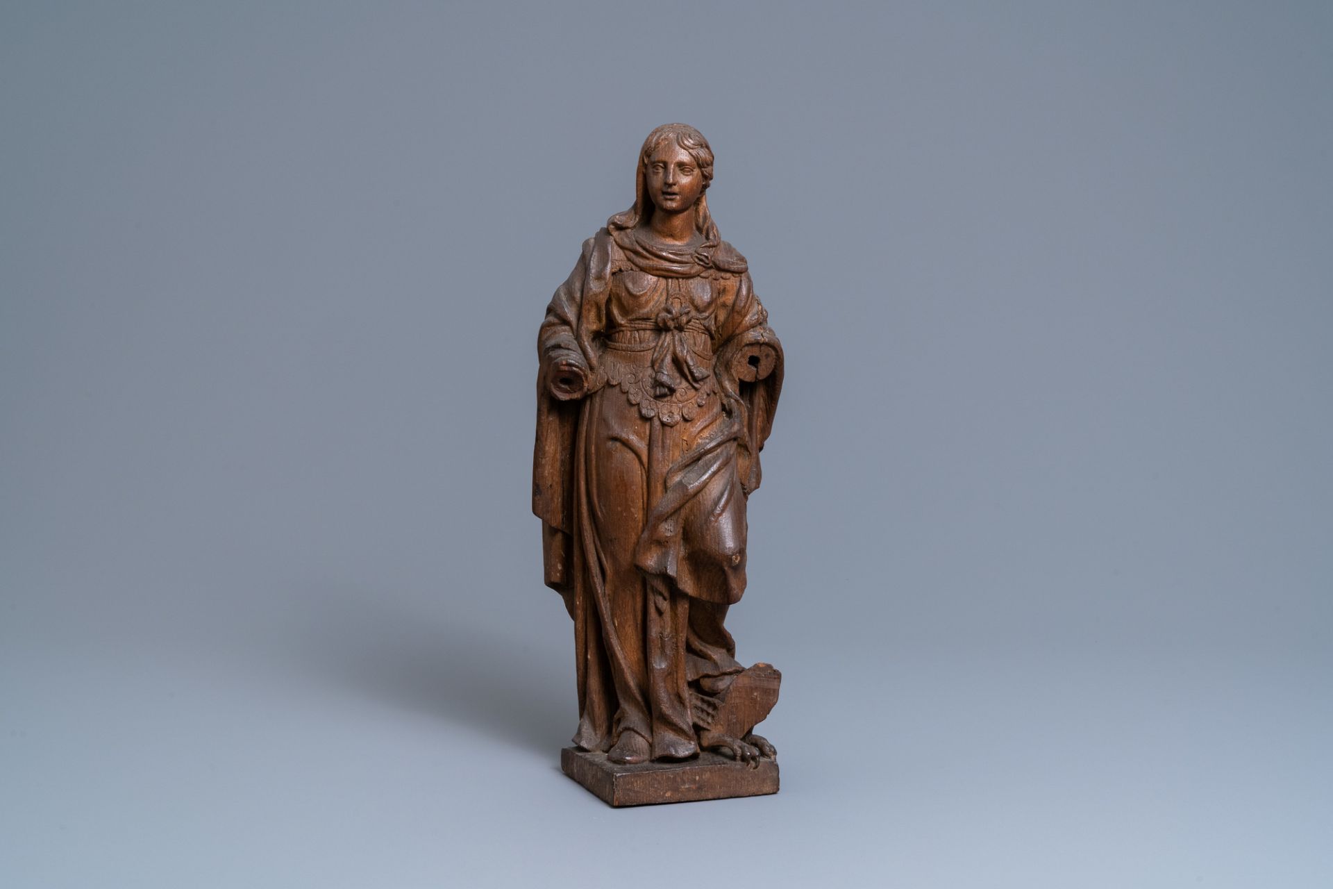 An oak figure of a female saint crushing a griffin, 2nd half 16th C.