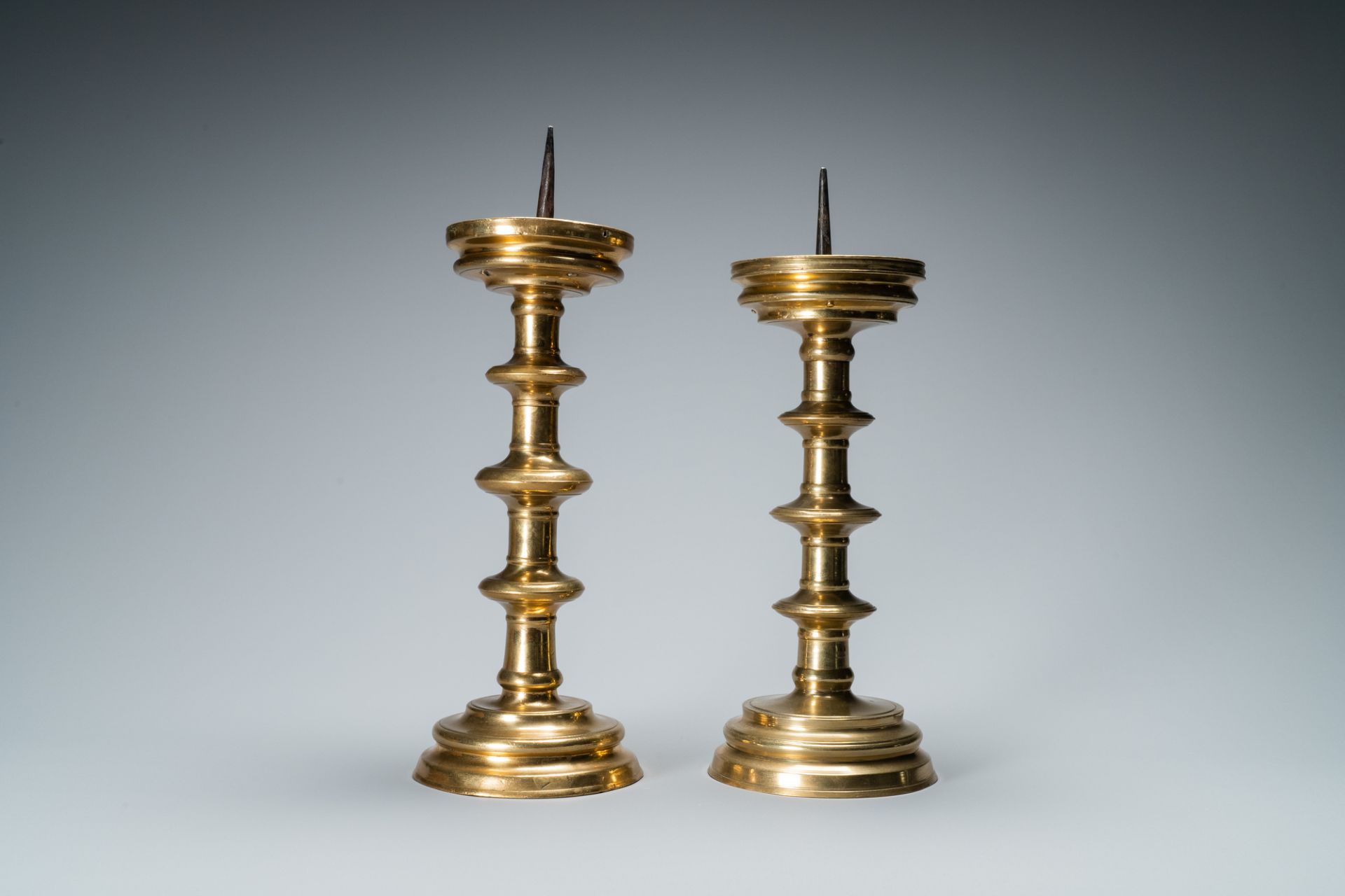 A composite pair of brass alloy candlesticks, Germany, 16th C. - Image 3 of 7