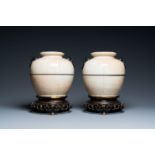 A pair of Chinese monochrome Nanking crackle-glazed vases on reticulated bronze stands, 19th C.