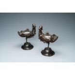 A pair of Chinese bronze censers modelled as ducks on a lotus flower, late Ming/early Qing