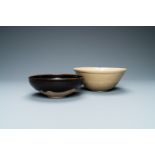 A Chinese black-glazed Cizhou bowl and a cream-glazed incised bowl, Song and/or later