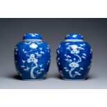 A pair of large Chinese blue and white 'prunus' jars and covers, 19th C.