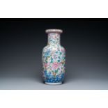 A Chinese pink-ground famille rose rouleau vase, 19th C.