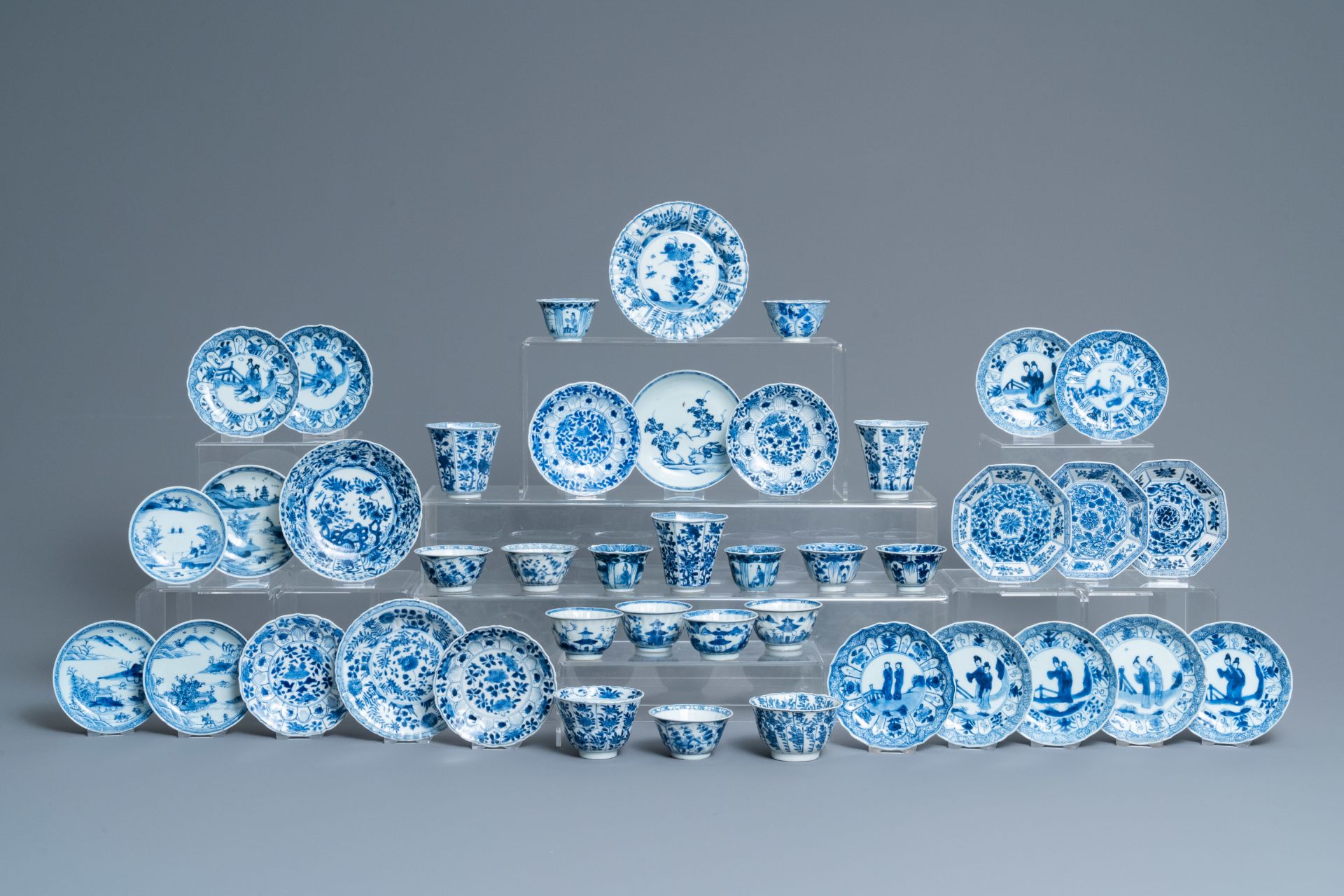 Twenty-one Chinese blue and white saucers and eighteen cups, Kangxi