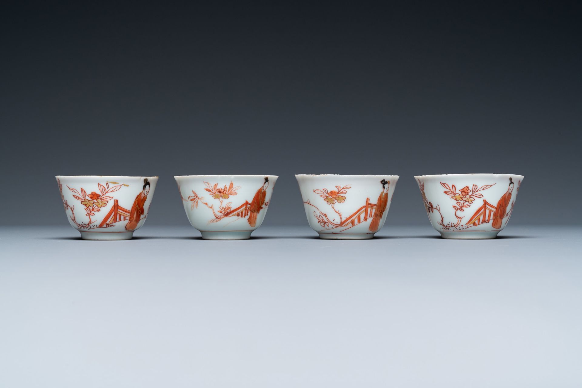 Four Chinese iron-red and gilt cups and saucers with figures near a table, Kangxi - Image 5 of 9