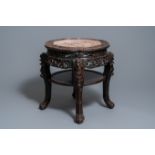 A Chinese carved wooden marble top stand, 19th C.