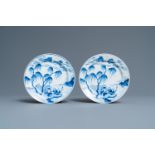 A pair of Chinese blue and white plates with a boat near the shore, Chenghua mark, Kangxi