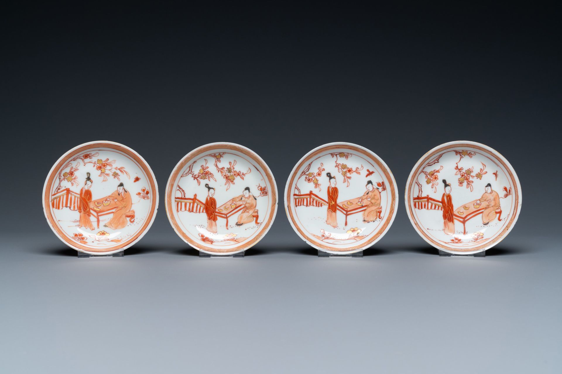 Four Chinese iron-red and gilt cups and saucers with figures near a table, Kangxi - Image 2 of 9