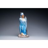 A large Chinese blue-glazed Shiwan pottery 'immortal' figure, 19th C.