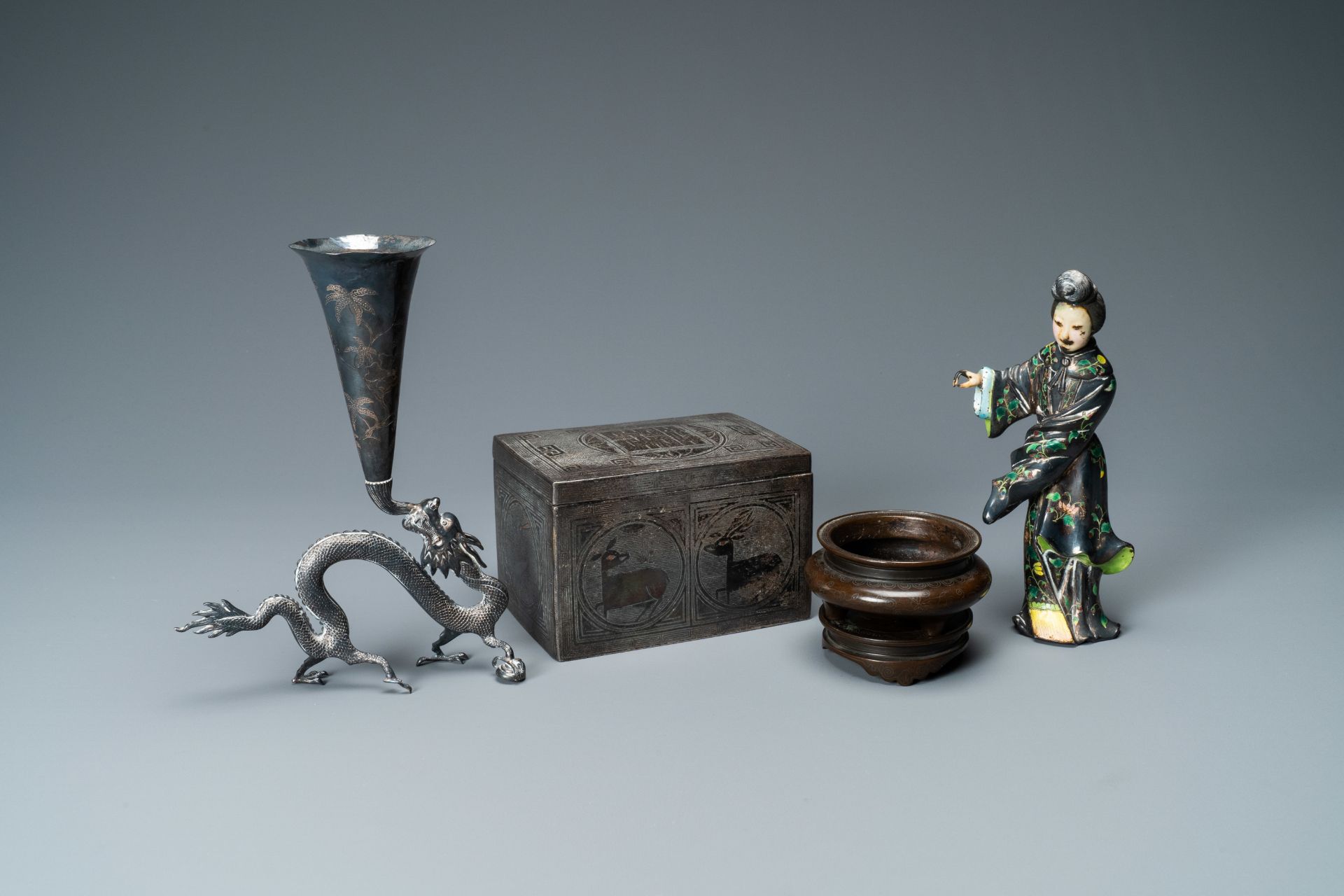 A Chinese enamelled silver figure, a silver vase, a silver-inlaid bronze censer and a silver-plated