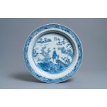 A large deep Chinese blue and white dish with a lady, Qianlong