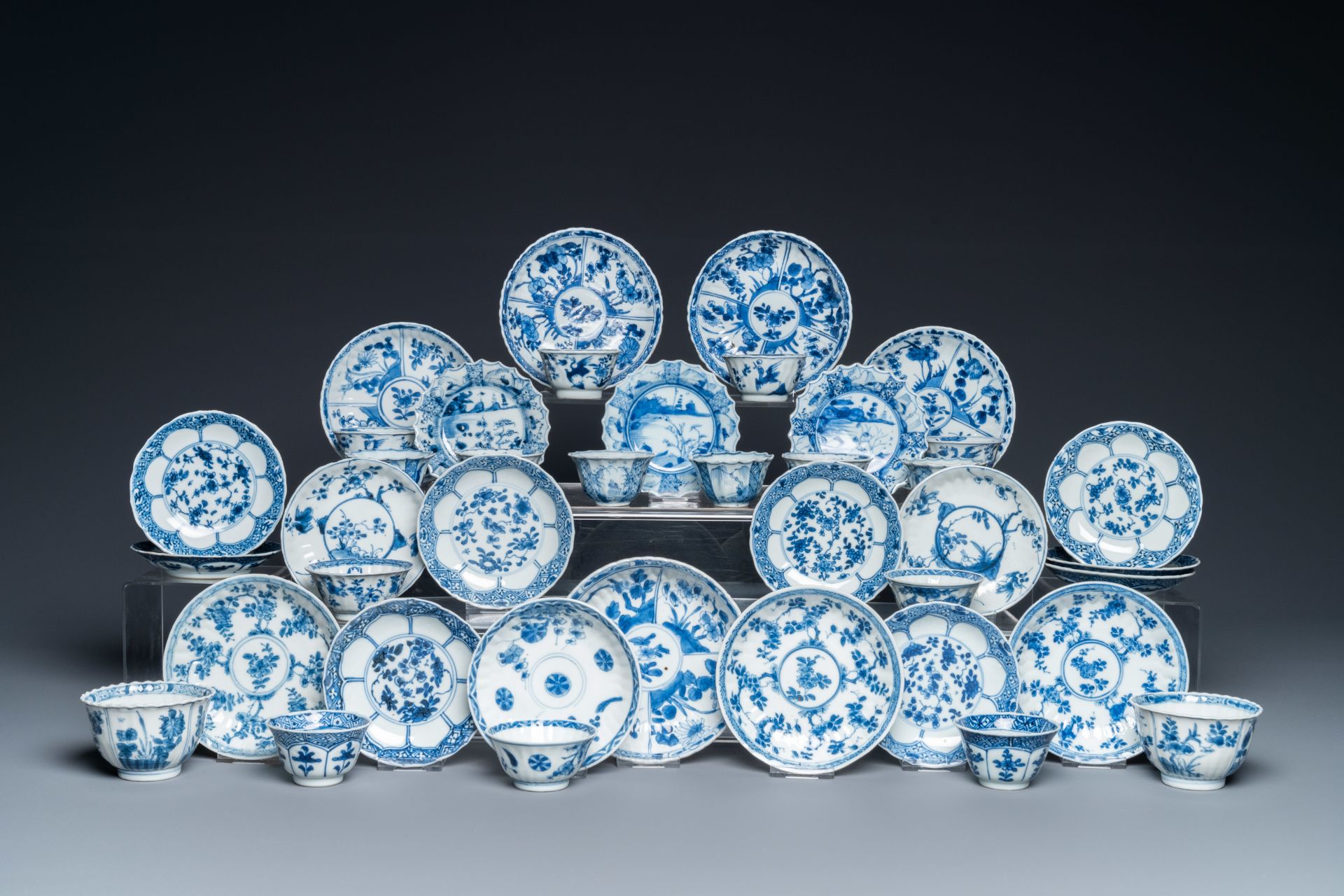 Twenty-three Chinese blue and white saucers and seventeen cups, Kangxi