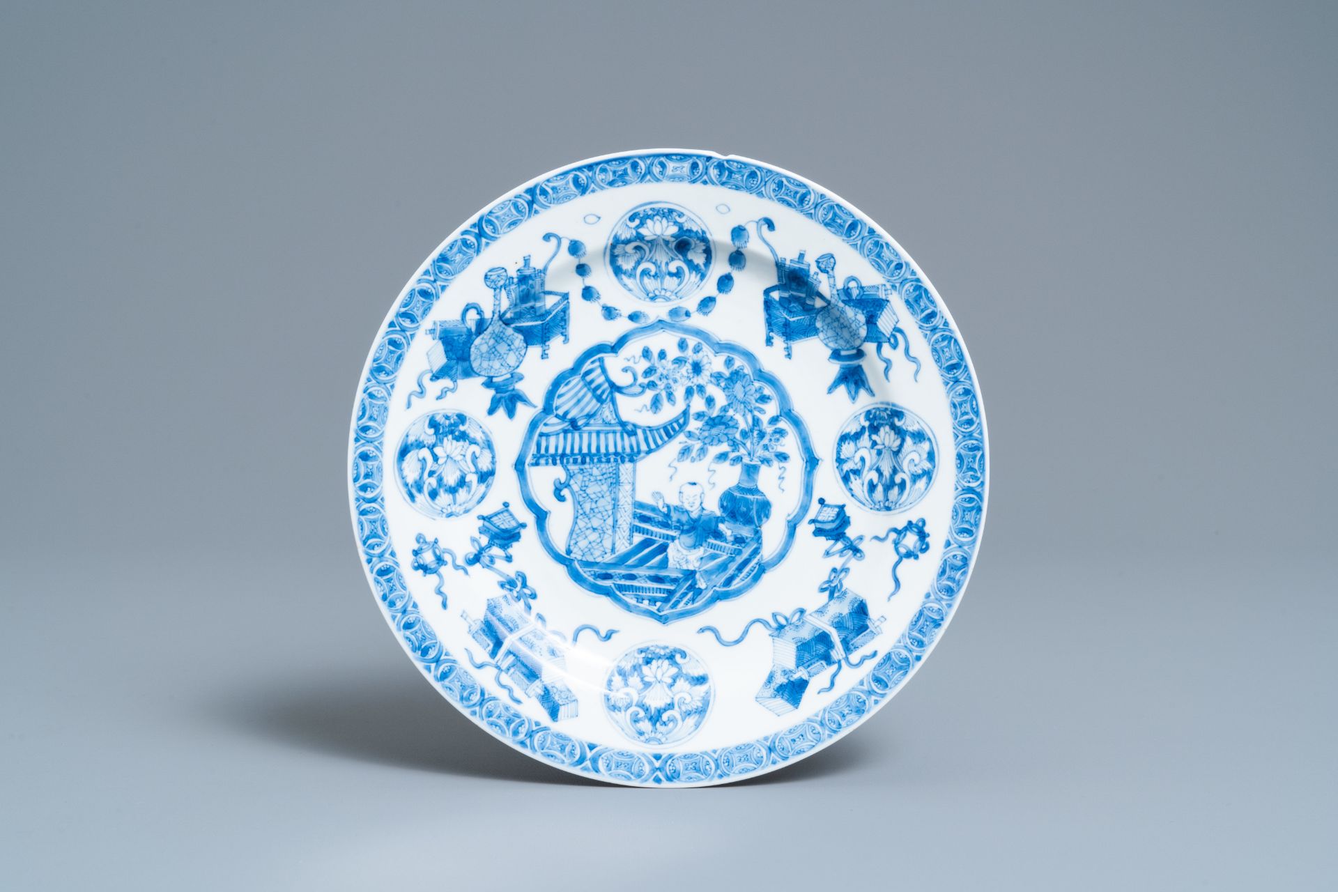 A Chinese blue and white plate with a boy surrounded by antiquities, ex-coll. August the Strong, Kan