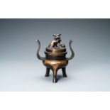 A Chinese partly gilded bronze tripod censer and cover, Ming