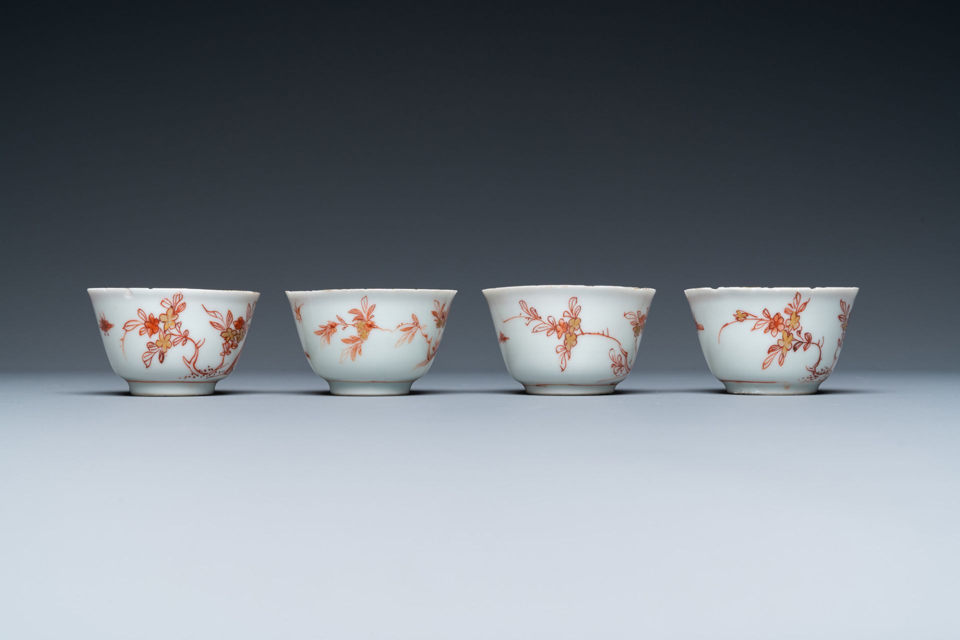 Four Chinese iron-red and gilt cups and saucers with figures near a table, Kangxi - Image 6 of 9