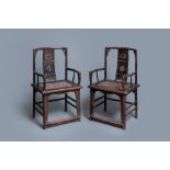 A pair of Chinese carved wooden chairs with wicker seats, 19th C.