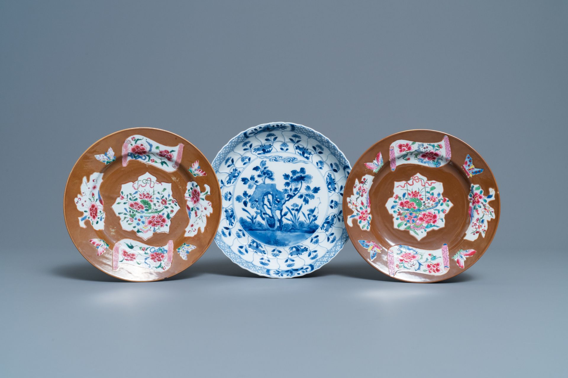 A pair of Chinese famille rose plates, Qianlong, and a blue and white plate, Kangxi mark and of the