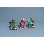 A Chinese famille rose model of a Buddhist lion and a pair of verte biscuit joss stick holders, 19th