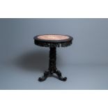 A round Chinese carved wooden marble top table, 19th C.