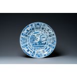 A large Chinese blue and white kraak porcelain dish with figures in a landscape, Wanli