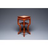 A Chinese carved wooden marble top stand, 19th C.