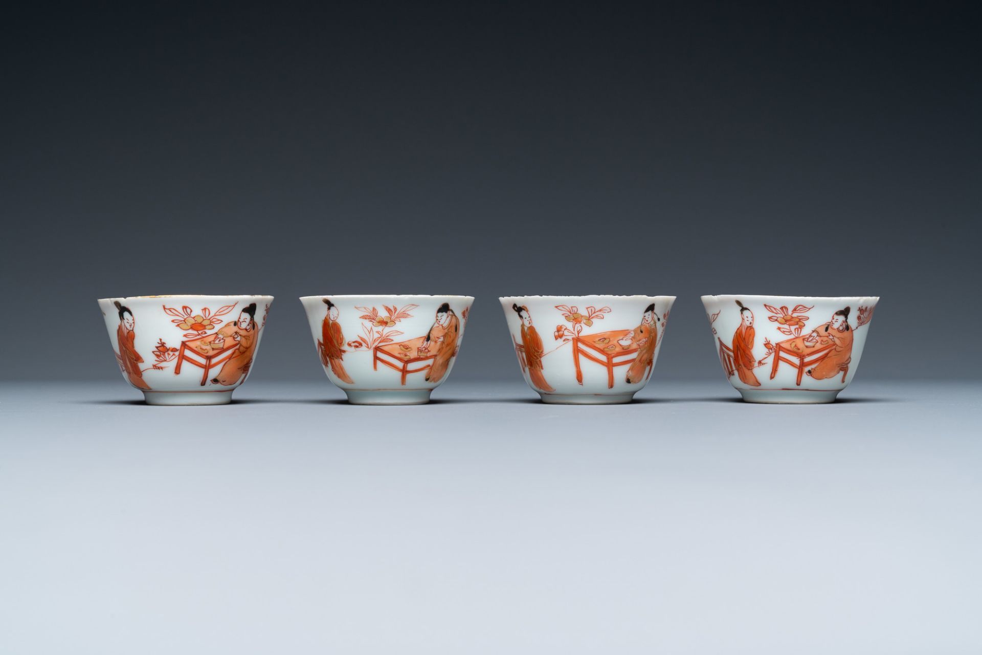 Four Chinese iron-red and gilt cups and saucers with figures near a table, Kangxi - Image 4 of 9