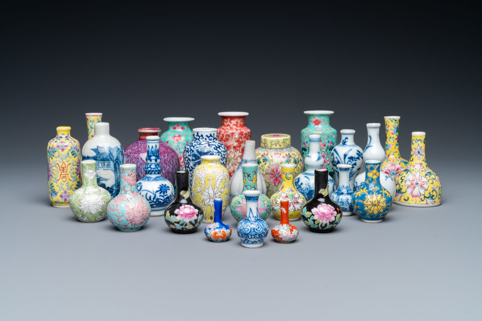 Twenty-eight Chinese blue and white and famille rose minature vases, Kangxi and later