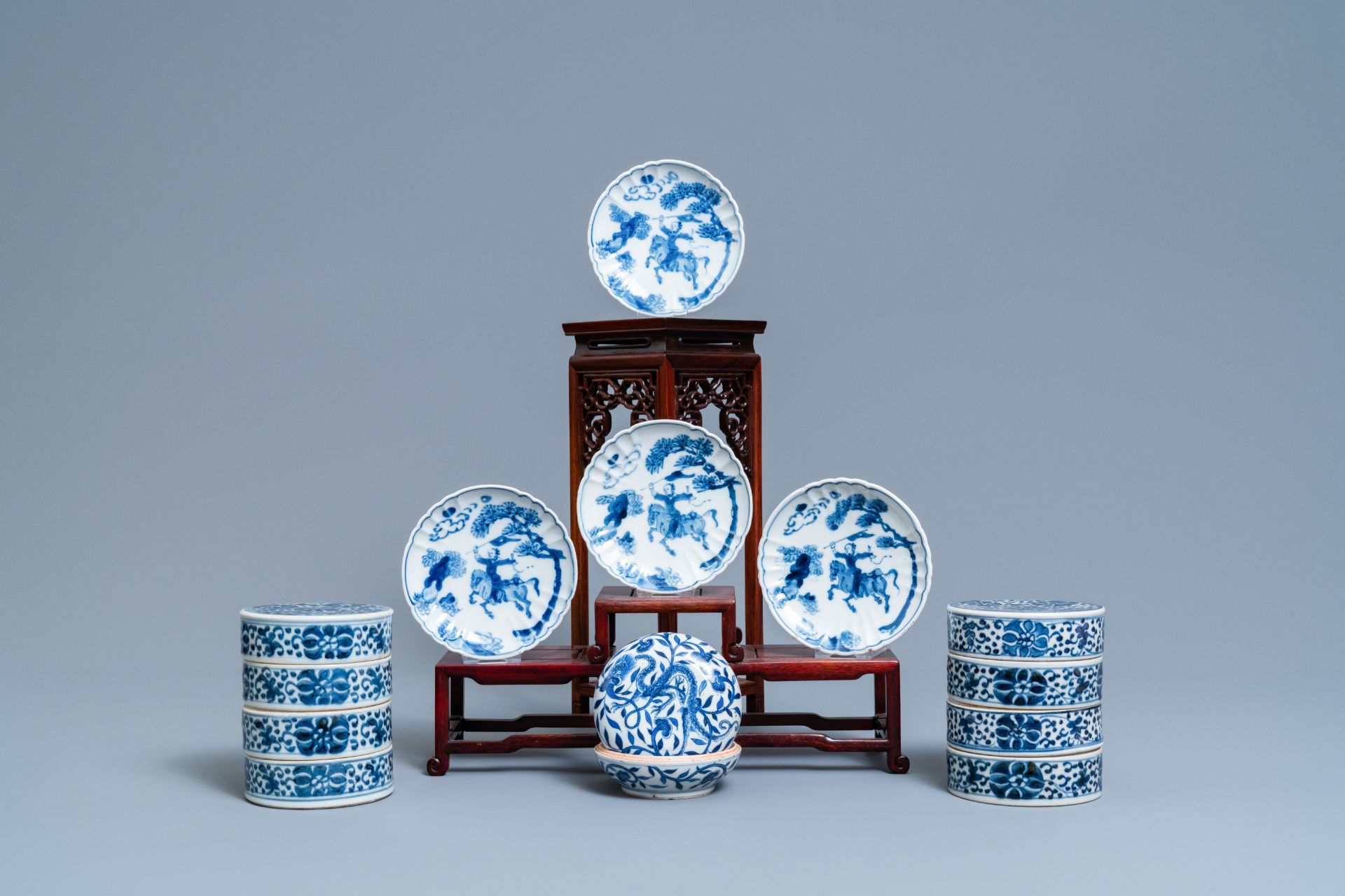 A pair of Chinese blue and white three-tier stacking boxes, a seal paste box and four saucers, 19th