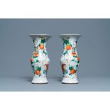 A pair of Chinese famille rose vases with boys hanging near pumpkins, 19th C.