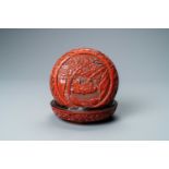 A Chinese round cinnabar lacquer box and cover with two scholars at a table, 18/19th C.