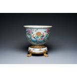 A Chinese famille rose jardiniere on ormolu bronze and porcelain stand, Qianlong