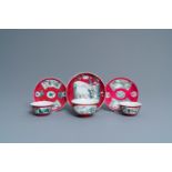 Three Chinese famille rose ruby-ground cups and saucers, Yongzheng