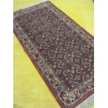 PERSIAN STYLE TASSEL ENDED CARPET and a yellow tufted example, the former on a red ground with