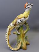 A CONTINENTAL PORCELAIN EXOTIC LONG TAILED BIRD ON A TRUNK, base unmarked, 25cms H