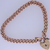 NINE CARAT GOLD CURB LINK BRACELET with chased decorated padlock clasp, all fully stamped, 27grms
