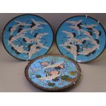 CLOISONNE - three chargers including a pair, blue ground with flying cranes, 30cms diameter and a