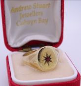 NINE CARAT GOLD GENT'S SIGNET RING, ruby set to a star decoration, 6grms, size T