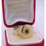 NINE CARAT GOLD GENT'S SIGNET RING, ruby set to a star decoration, 6grms, size T