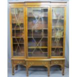 EDWARDIAN SHERATON STYLE INLAID BREAKFRONT BOOKCASE/CABINET having three lower drawers on square