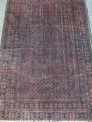 OLD BALUCHI RUG deep red and blue ground with multi-bordered edging, 138 x 92cms