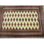 EASTERN STYLE WOOLLEN CARPET, red and cream ground with multi-diamond block central panel and